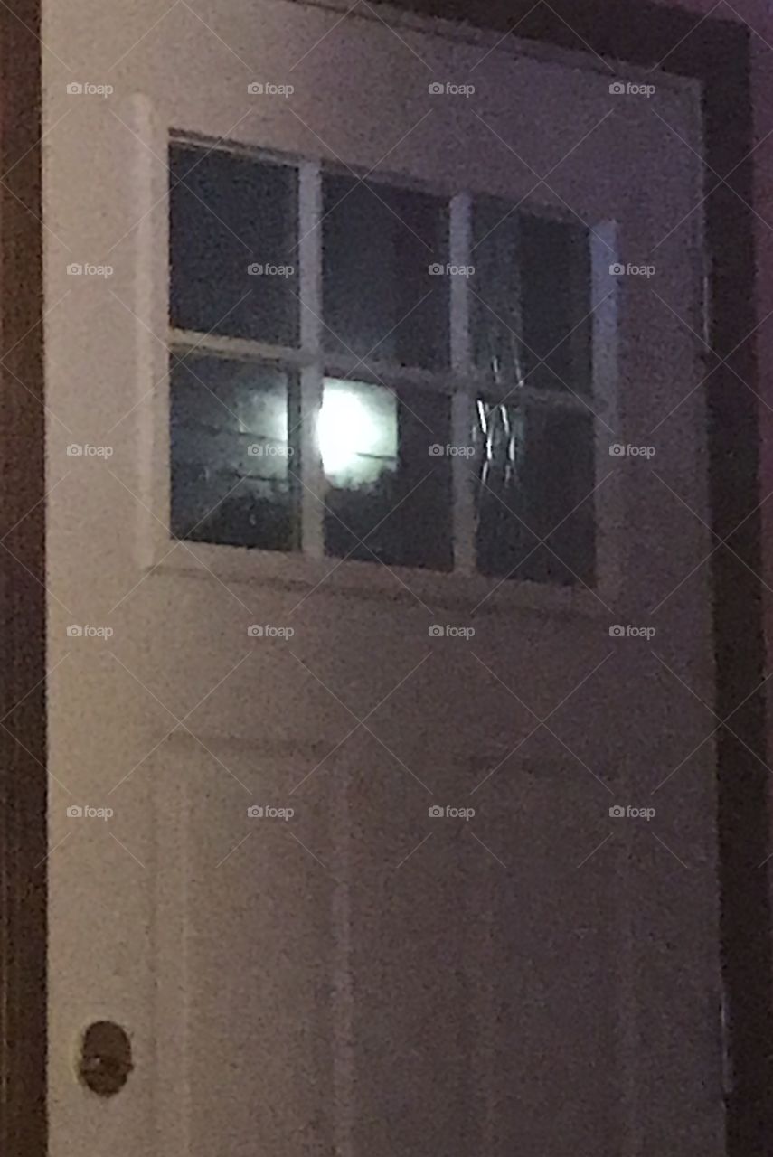 Moon through window in door 