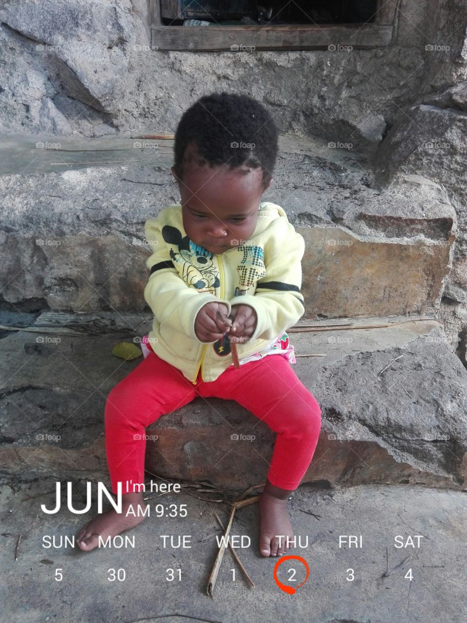 African little boy sitting on old staircase and calendar