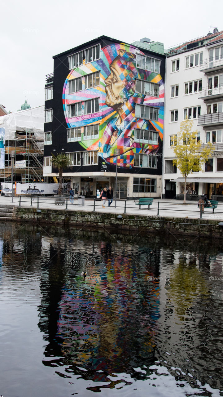 giant building mural reflecting onto the river in Borås Sweden