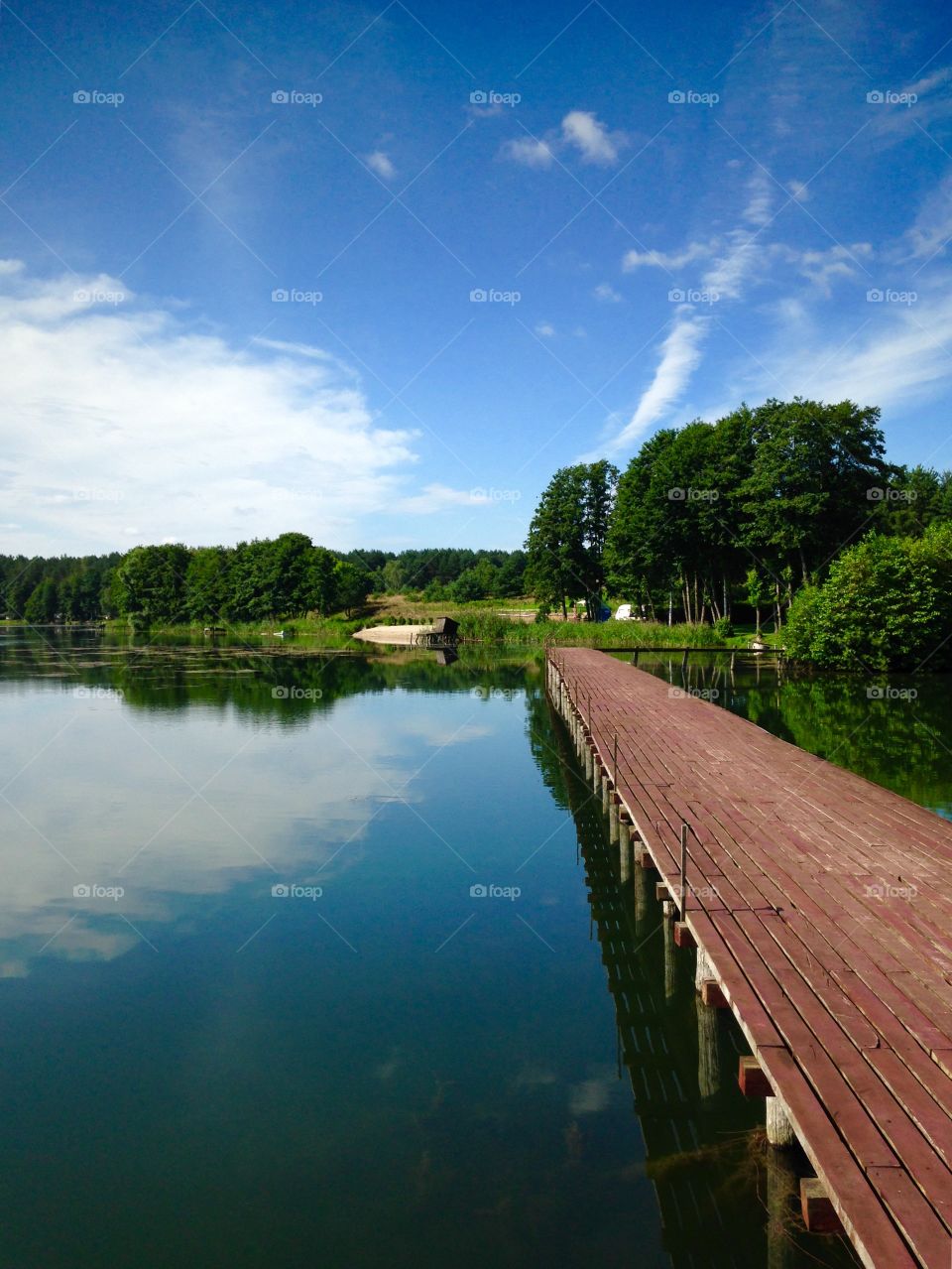 Wooden pier on the lake during summer week end in polish countryside mazury region 