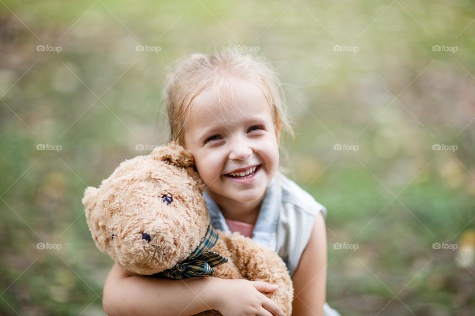 Candid portrait of happy little Caucasian girl outdoor