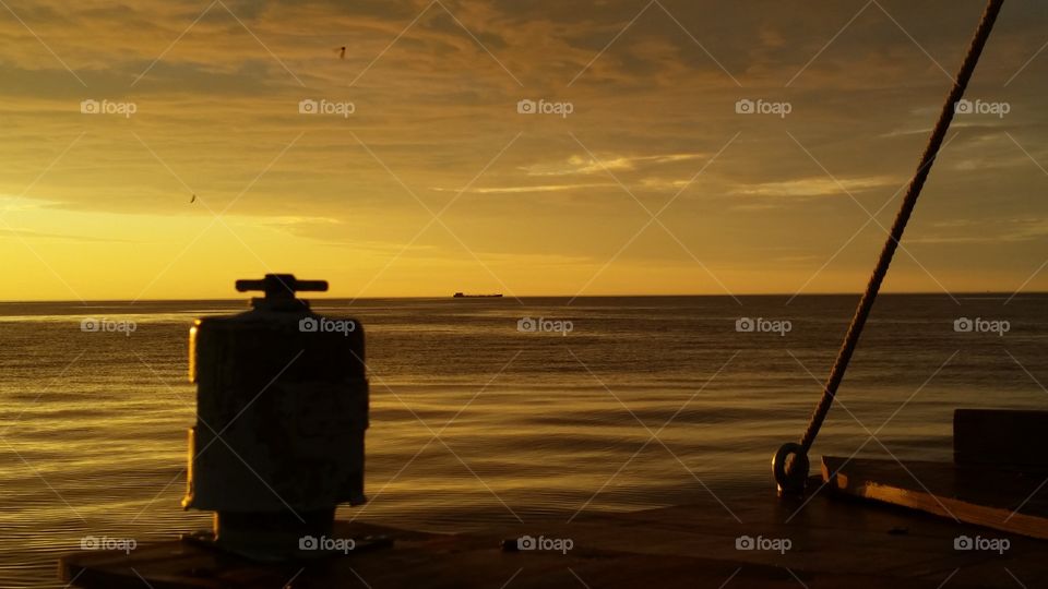 sunset and cargo ship away