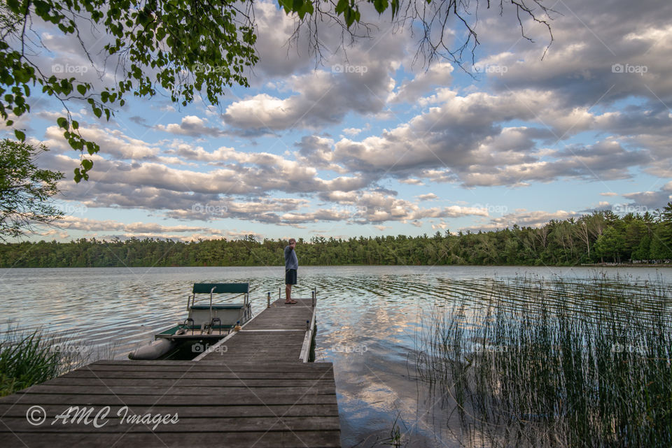 Pier with a paddle boat with beautiful big white clouds on Europe lake in door County, Wisconsin