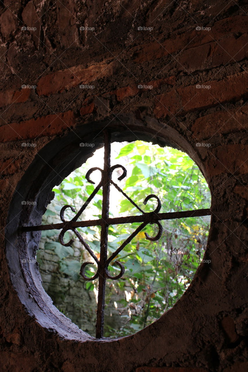 Ancient circular window at St Monica's church Laoag Philippines 