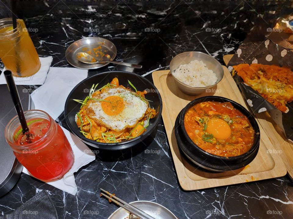 Korean Spicy Chicken Rice with Poached Egg and Kimchi Tofu Casserole with Egg.Fruit sparkling drink.