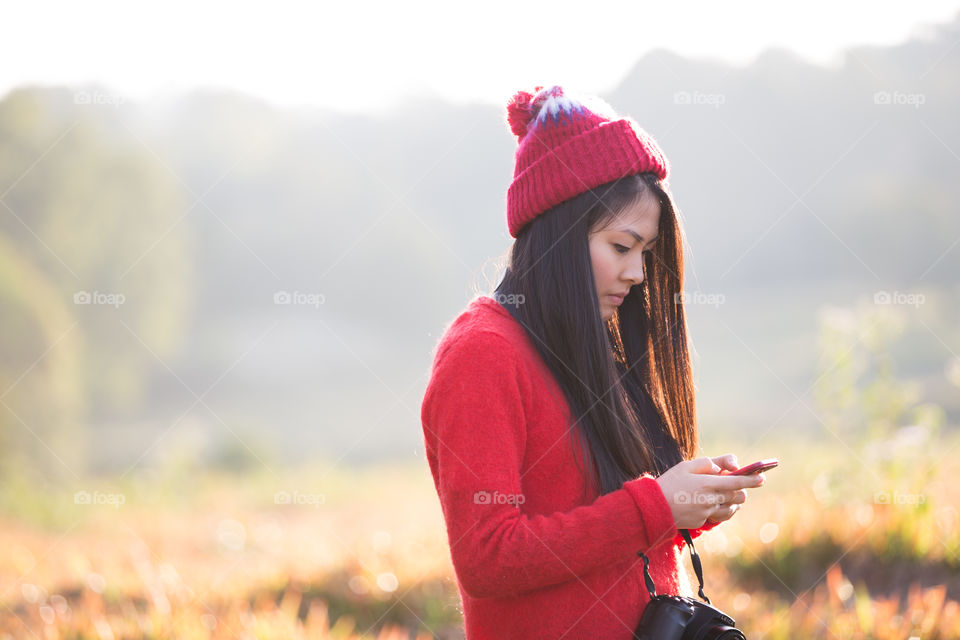 Asian girl playing smartphone 