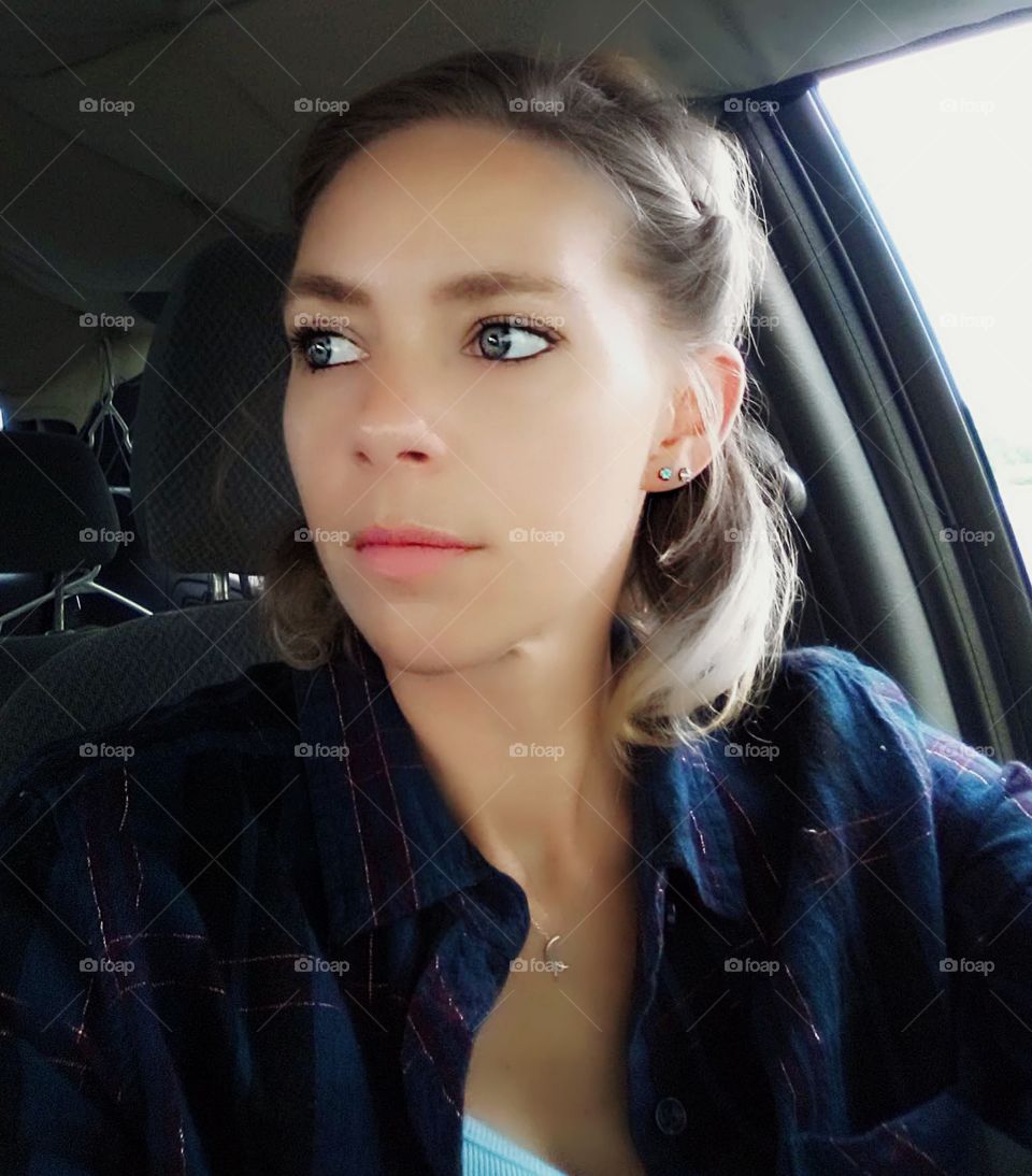 woman looking to side in car driver seat