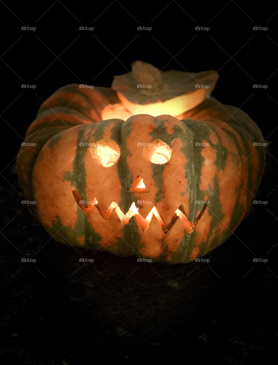 Halloween carved pumpkin on a black background