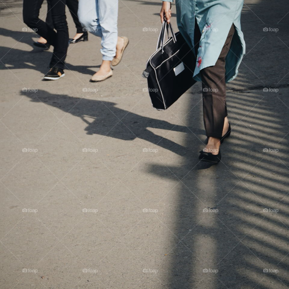 A busy woman and her shadow.