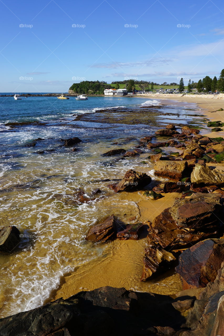 Rocks at Terrigal beach. Ocean and rocks at Terrigal beach with boat shed