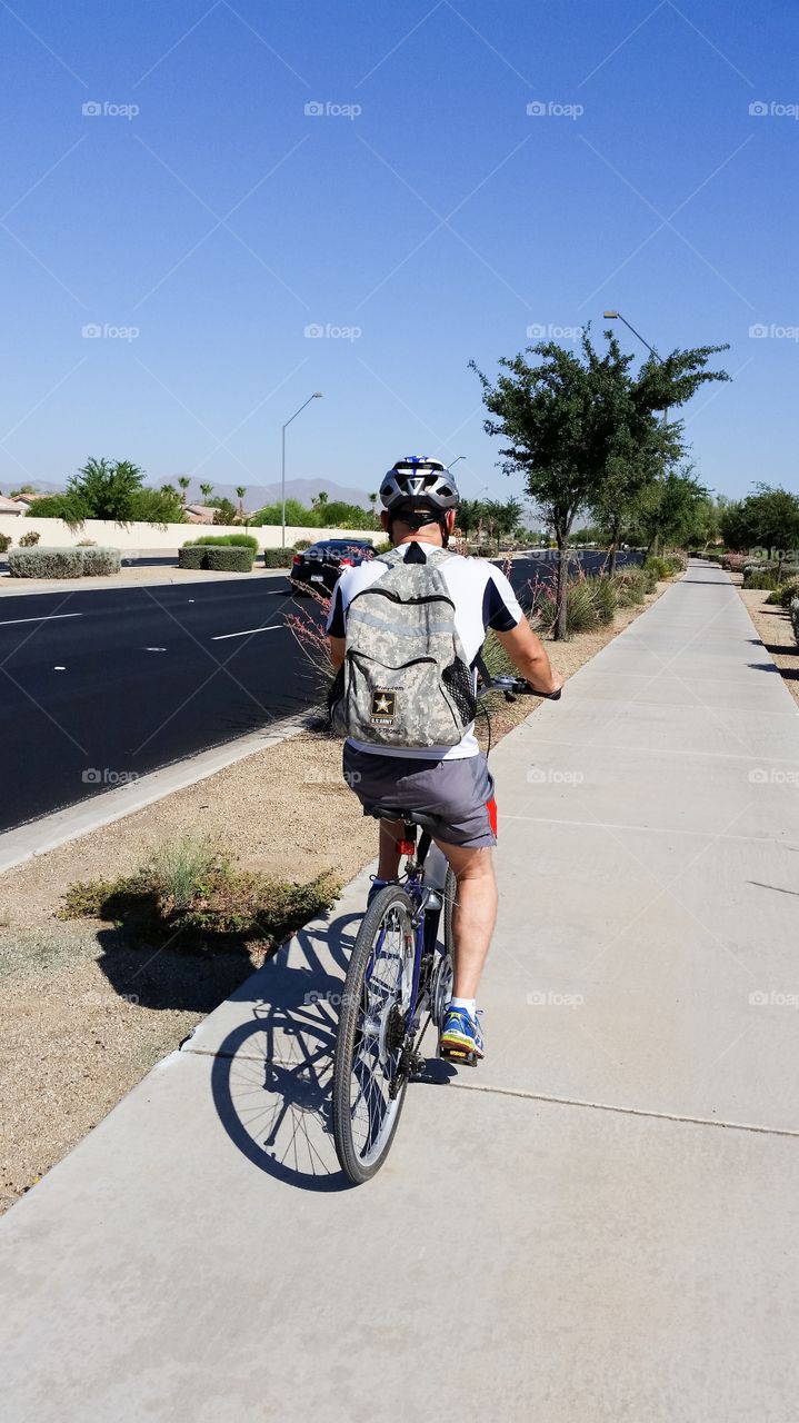 Rear view of a man riding bicycle