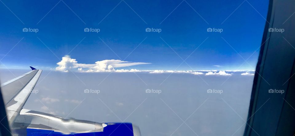 The clouds are raging for war from above the sky level. It forms a beautiful artwork in blue and white