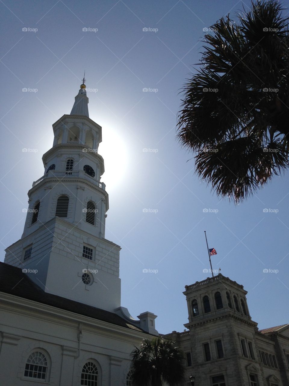 The sun behind a historic Charleston building.