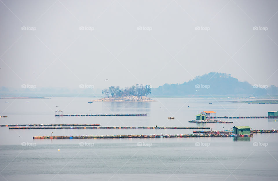 The raft floating fish farming and birds in Krasiew dam ,Supanburi Thailand.