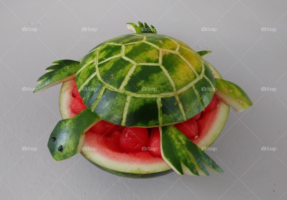 Watermelon carved into a turtle with edible watermelon pieces in the bowl section. Fun and easy with practice! I used a chopstick to do most of the etching 👍 It helps to keep it all the same width. I used chocolate syrup for the eyes(made little holes and filled them). Also used cut toothpicks to keep the arms and head attached to the 'shell'.