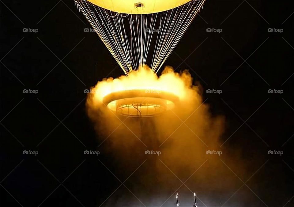 The olympic cauldron rising slowly in the dark sky of Paris closing the 2024 Olympic Games opening ceremony