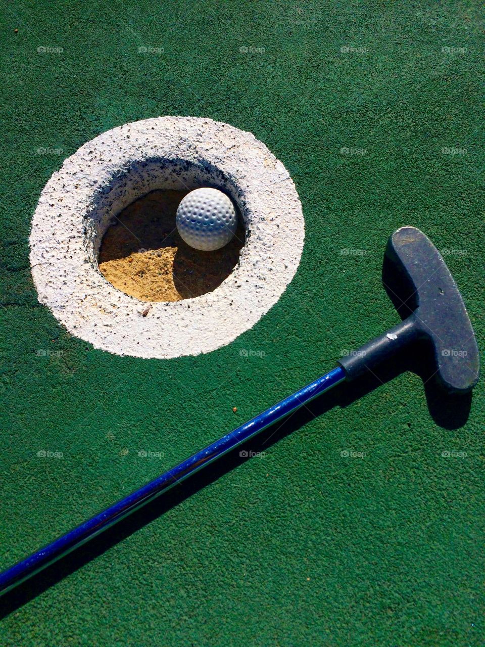 Close-up of golf ball and putter