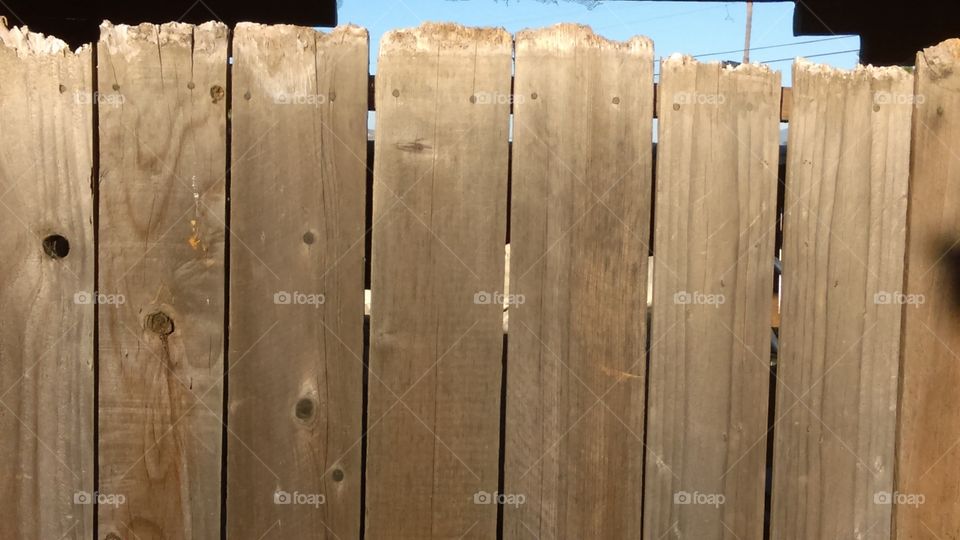 Salvaged wood cobbled together to make a temporary fence.