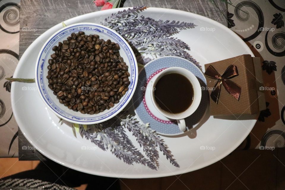 A cup of coffee and coffee beans