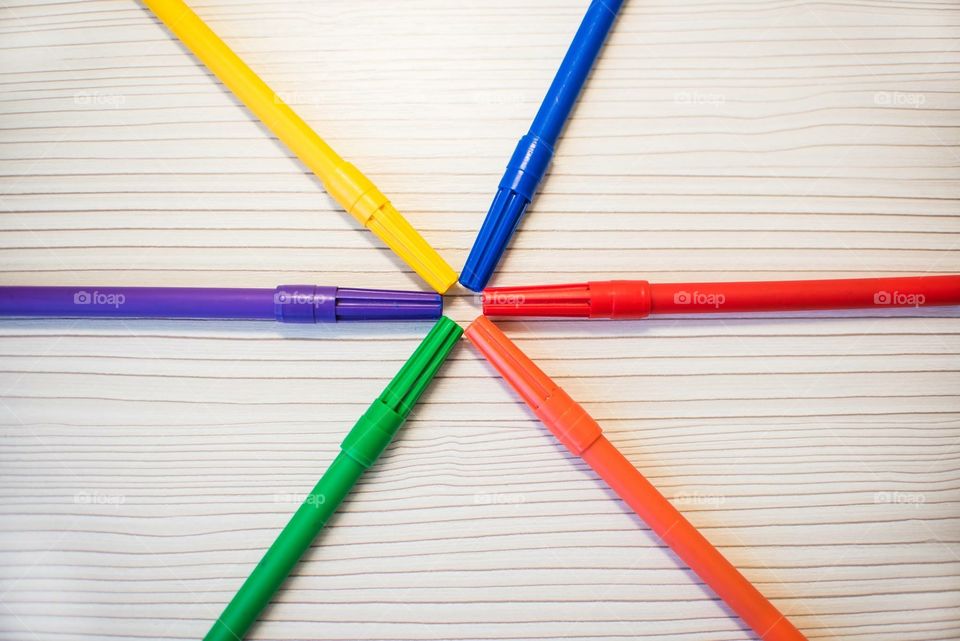 Multicolored Markers On A Wooden Background