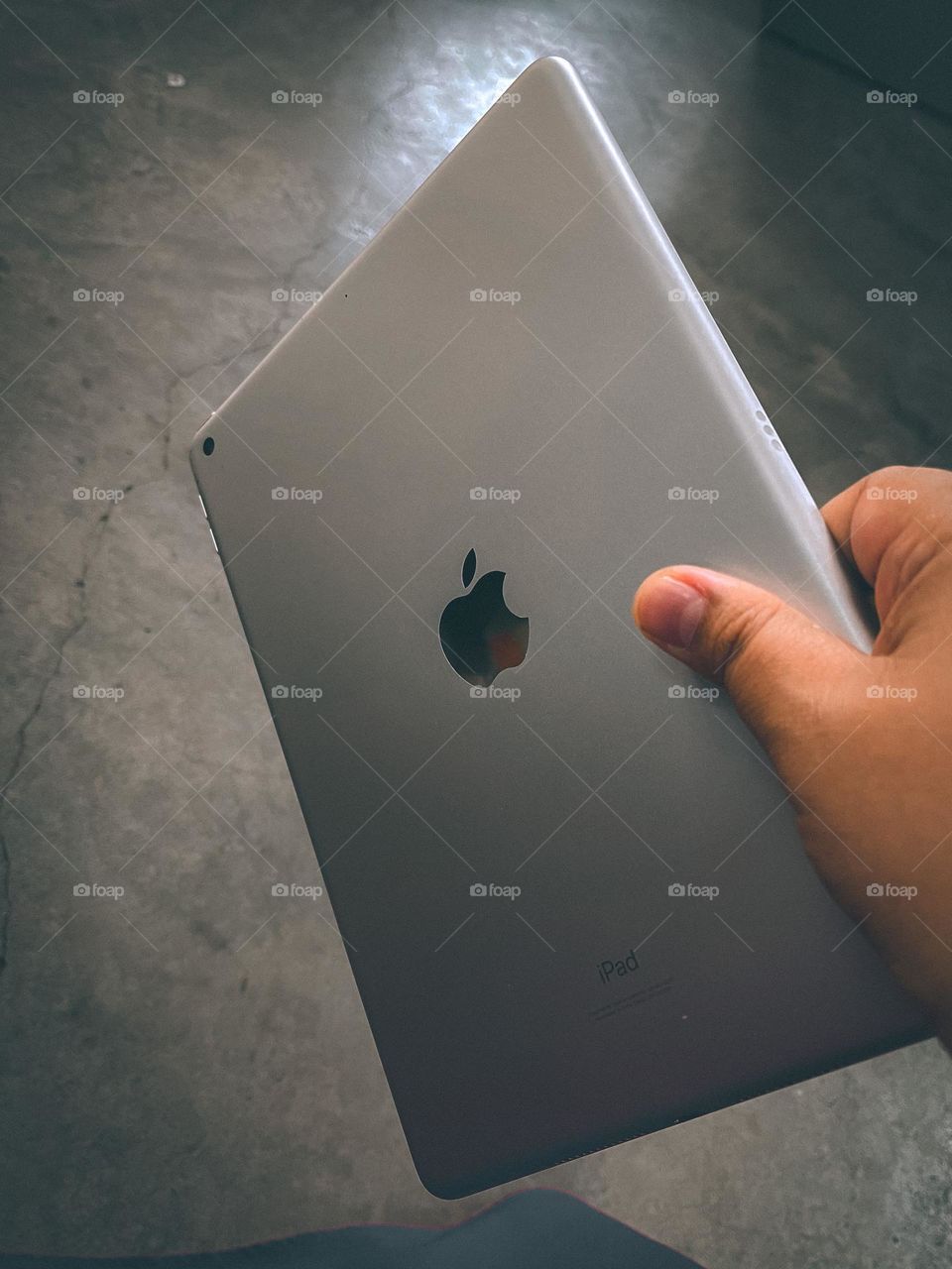 Hand holding and ipad. High angle view