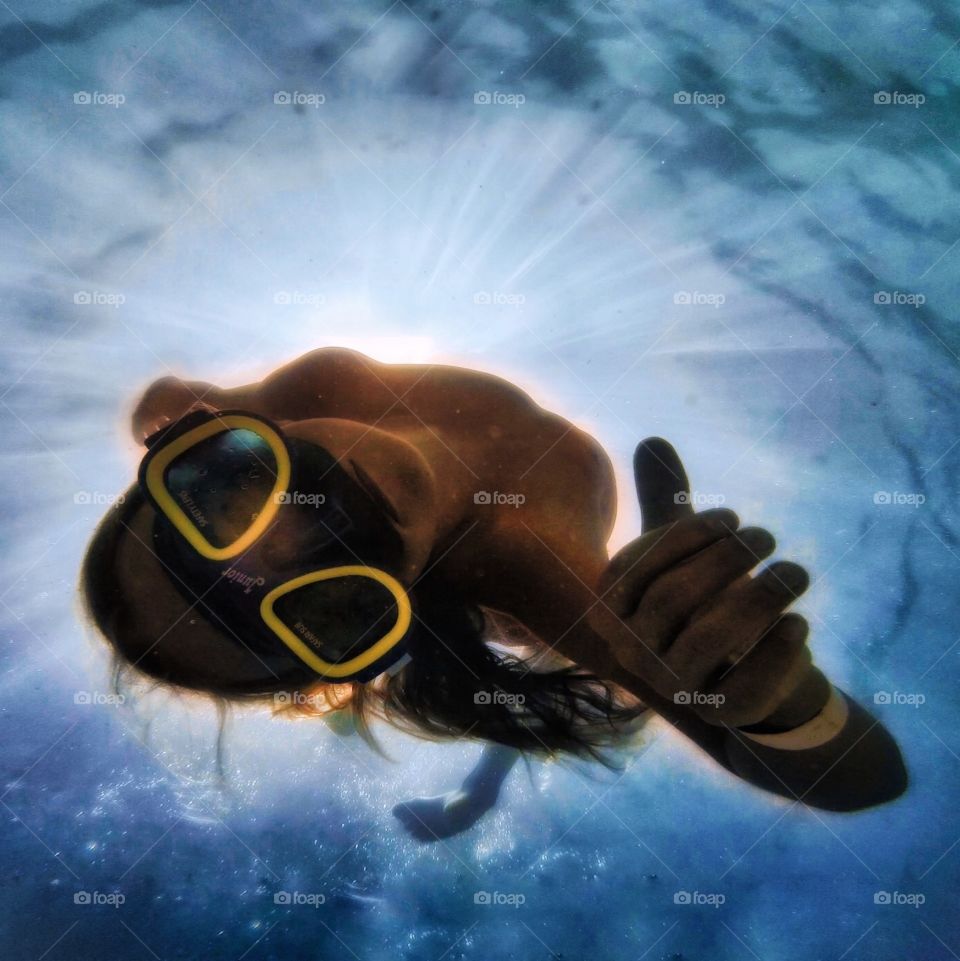 Young girl diving towards camera bottom