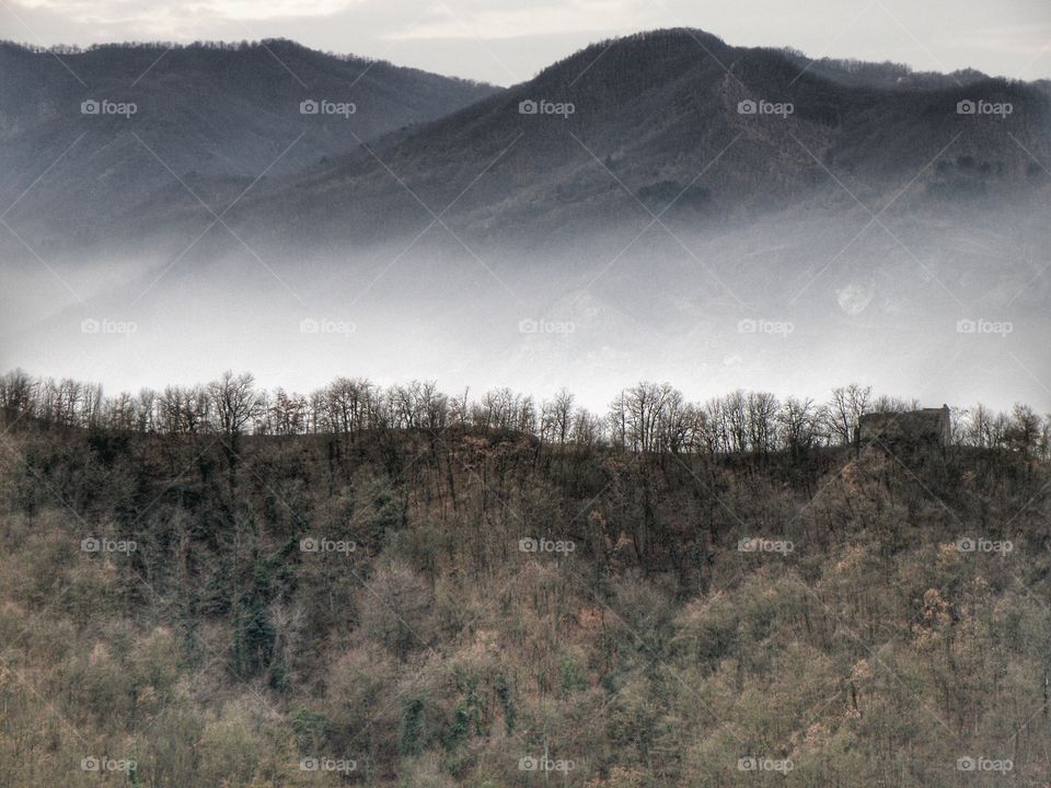 Scenic view of mountains in fog