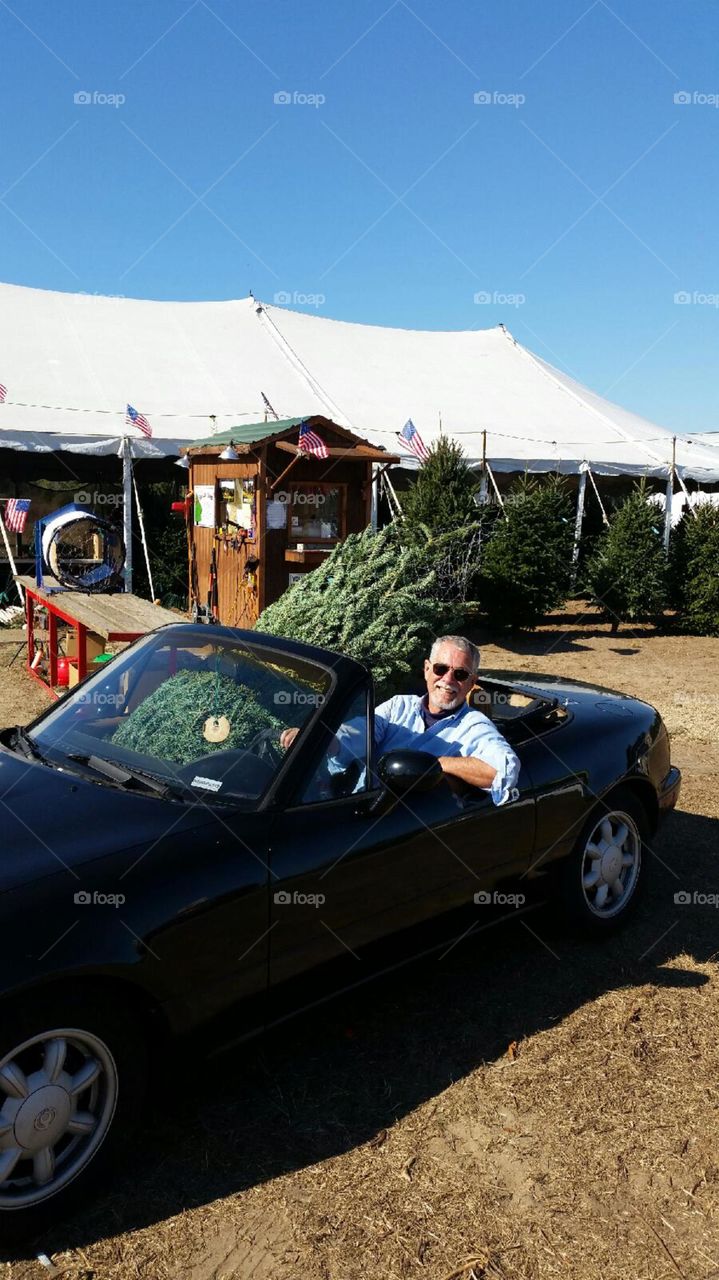 Christmas Tree. The only vehicle we had to pick up our Christmas tree was a Miata, so this is how we got it home.