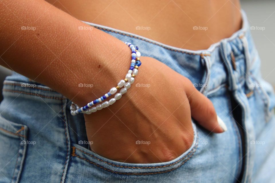 Female teenager in jean shorts wearing bracelet 