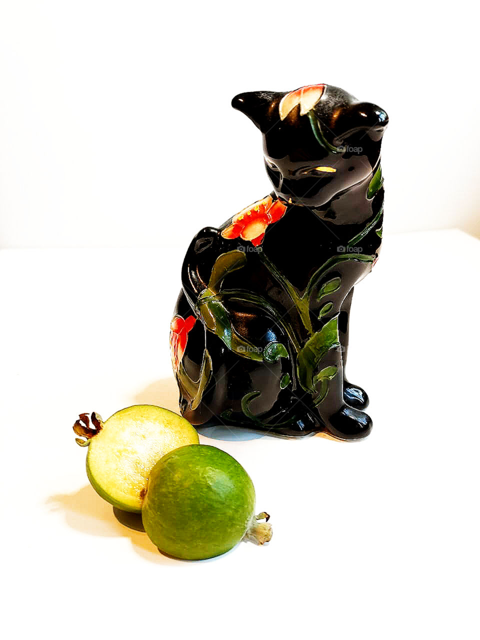 Feijoa and cat figurine