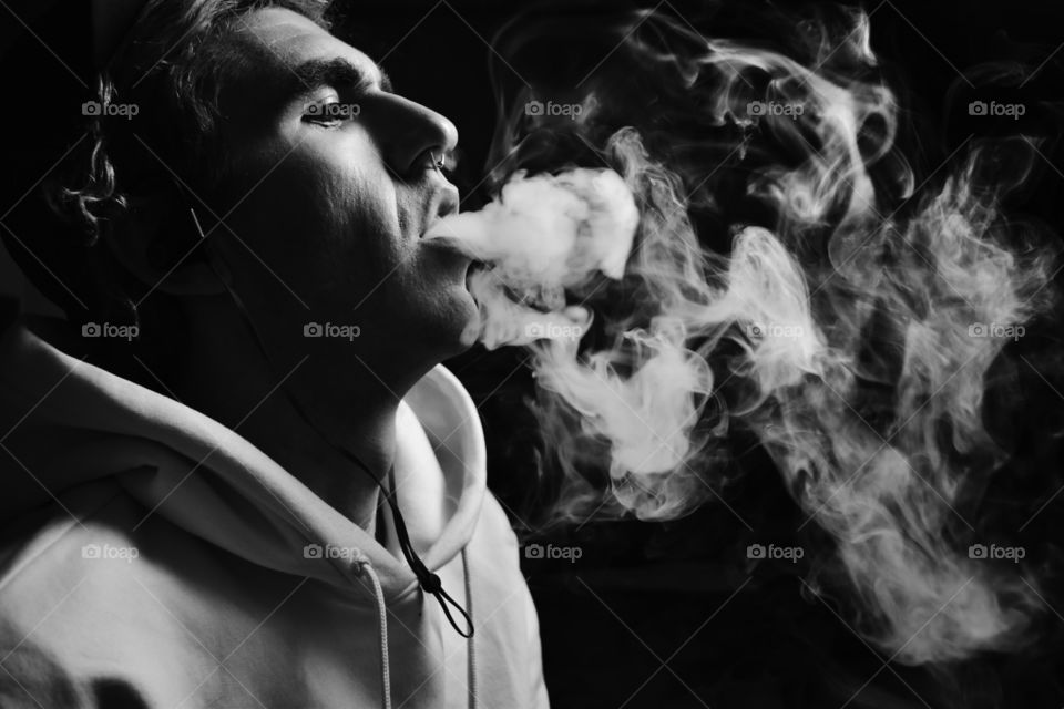Portrait of a man exhaling smoke