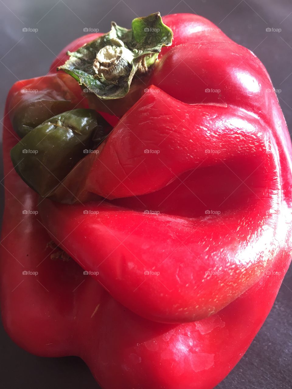 Funny beat up Face on a sweet red bell pepper