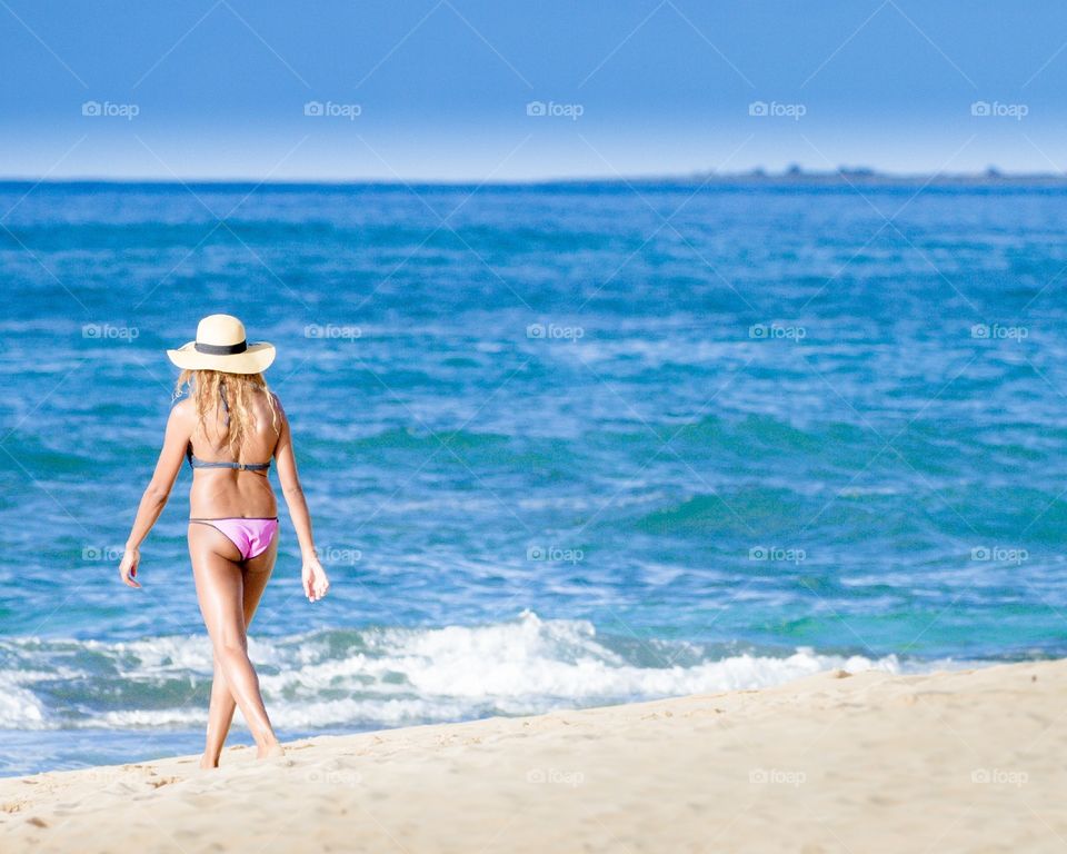 Woman strolling on beach. 