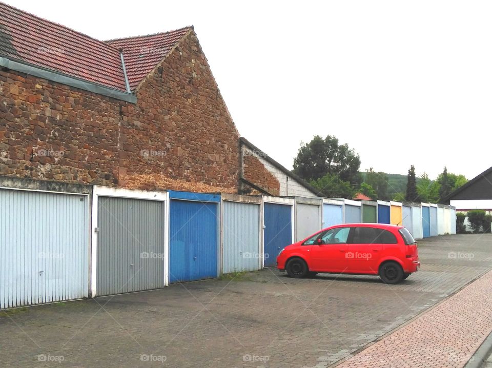 red car and blue garage