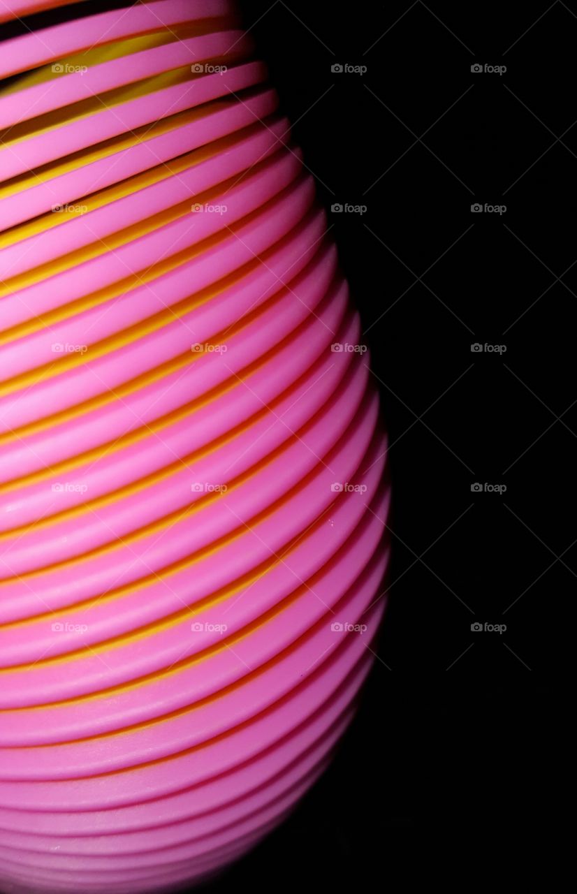 pink and yellow slinky toy