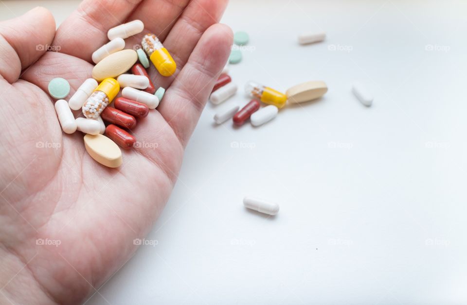 Assorted pills in hand 