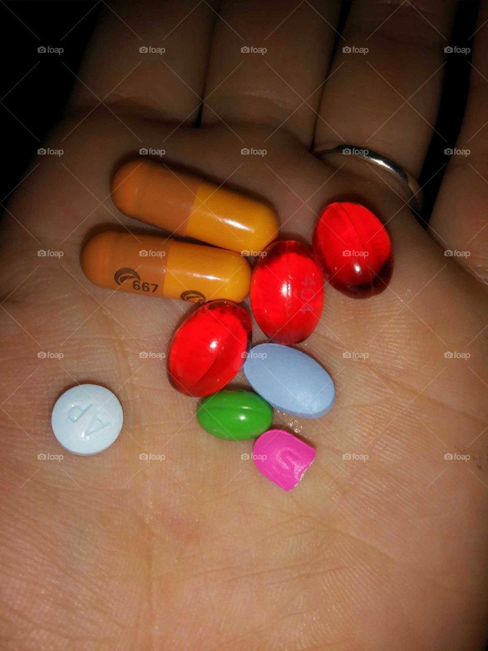 Handful of bright multicolored pills.