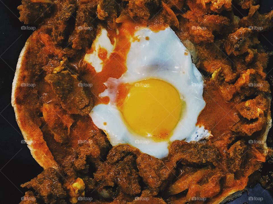 Hot and spicy prata with egg and beef curry