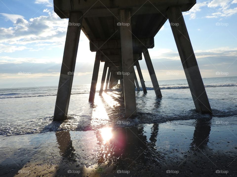 Sunlight casting shadows across the water. Johnnie Mercer's Pier.