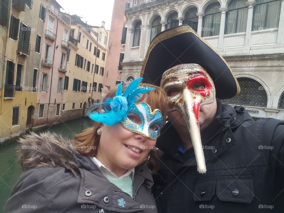 Couple wearing carnival mask