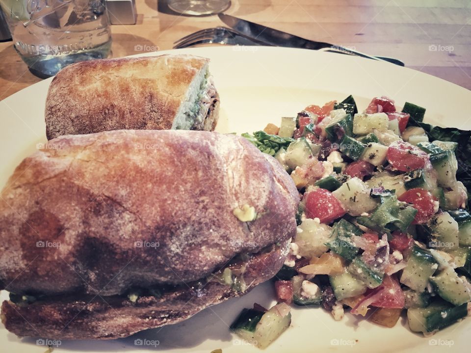 A hearty combination of a Cuban sandwich with Greek salad