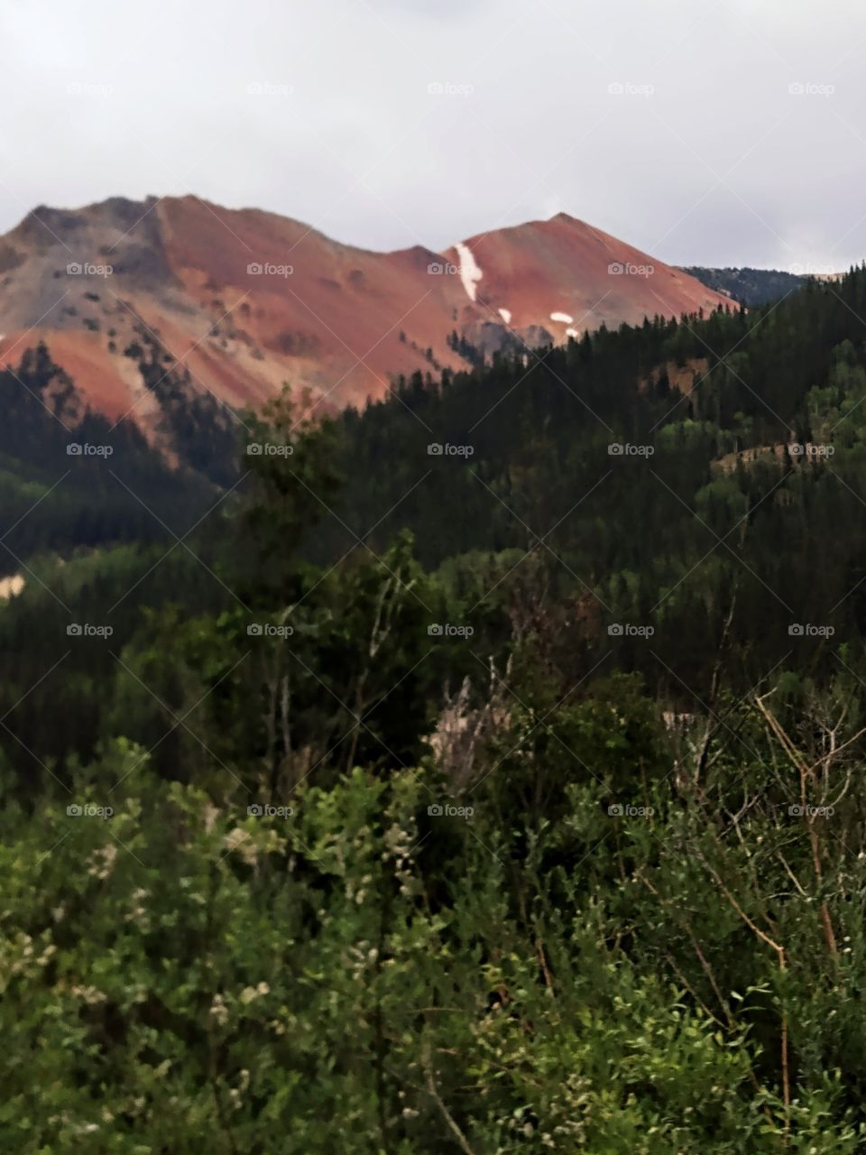 Red Mountain in the beautiful colorful Colorado Rocky Mountains landscape with just a touch of snow.