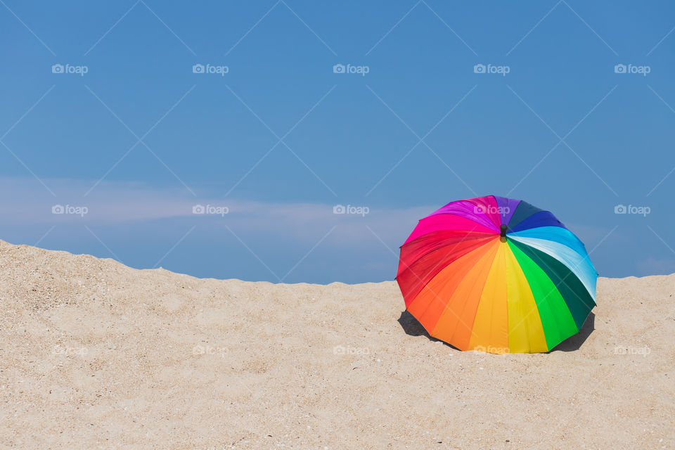 Colorful umbrella on the beach and the blue sky