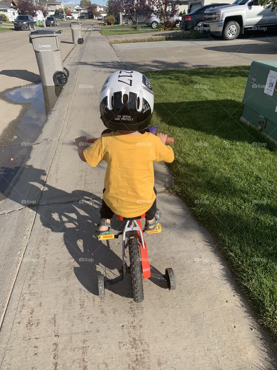 Son riding his bicycle 