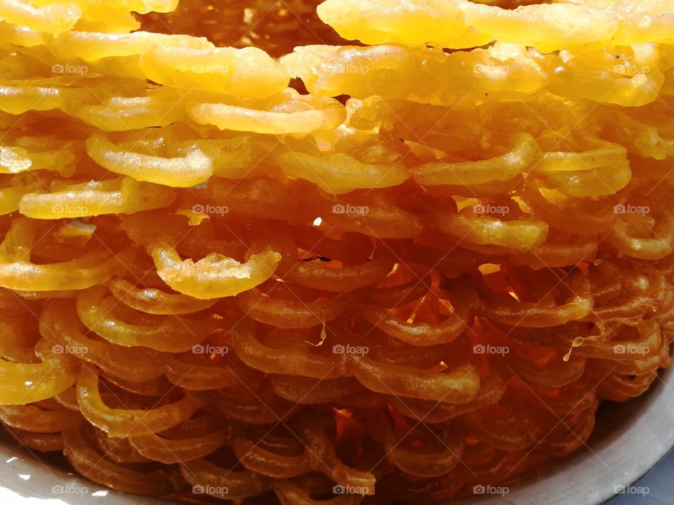 Jalebi,  is an Indian sweet and popular street sweet food  found all over South Asia and the Middle East. It is made by deep-frying maida flour  batter in pretzel or circular shapes, which are then soaked in sugar syrup.
