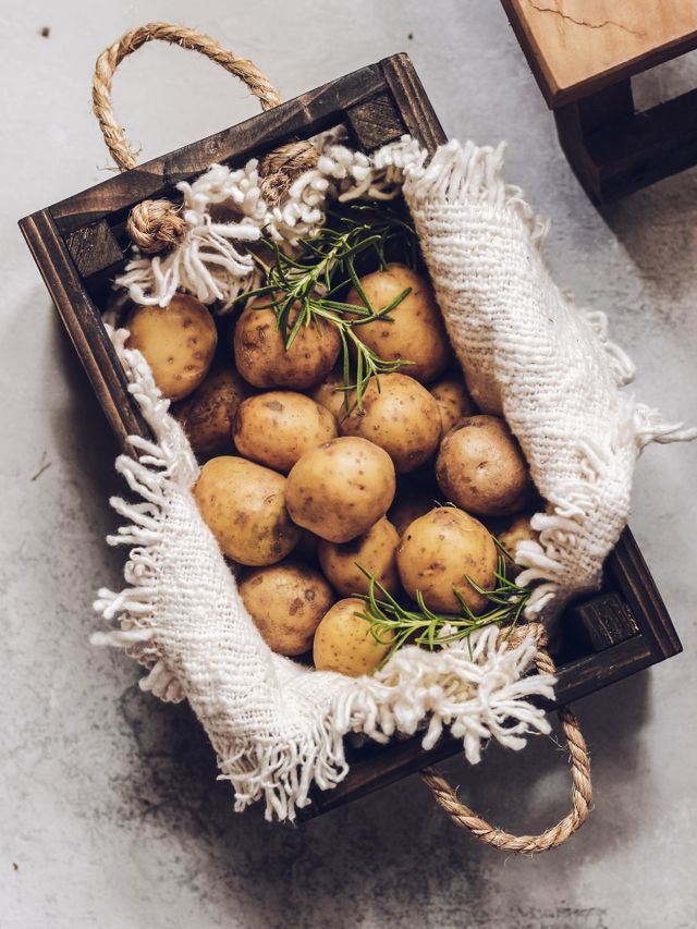 Baby potato in wooden box with napkin above