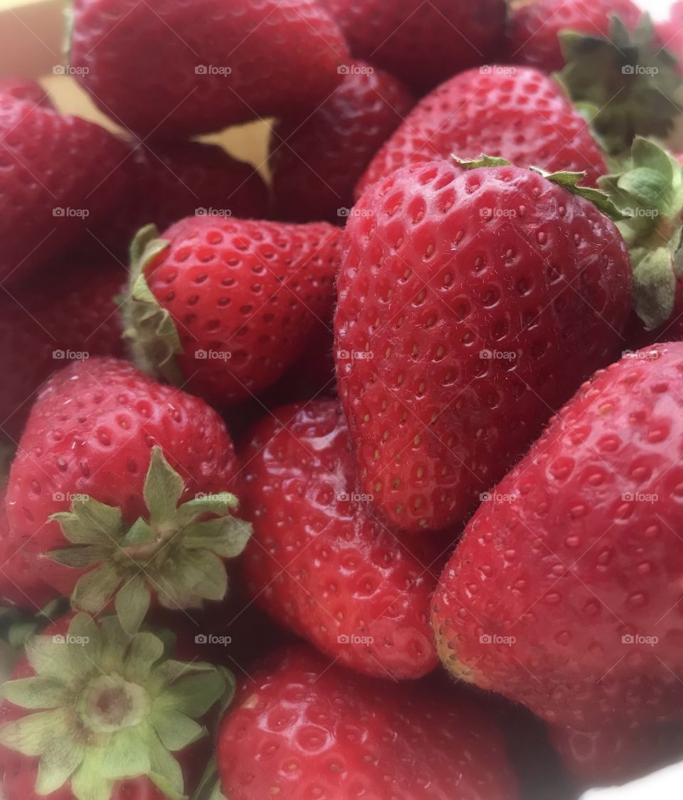 Ripe, local, Red,  strawberries with green stems. 