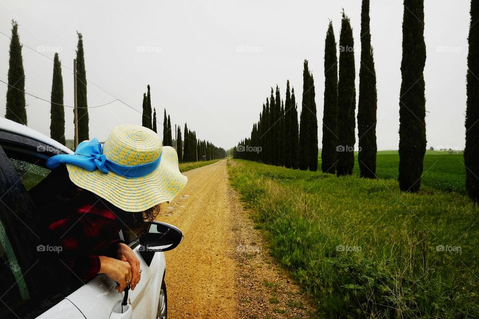 Woman travels by car and looks out the window