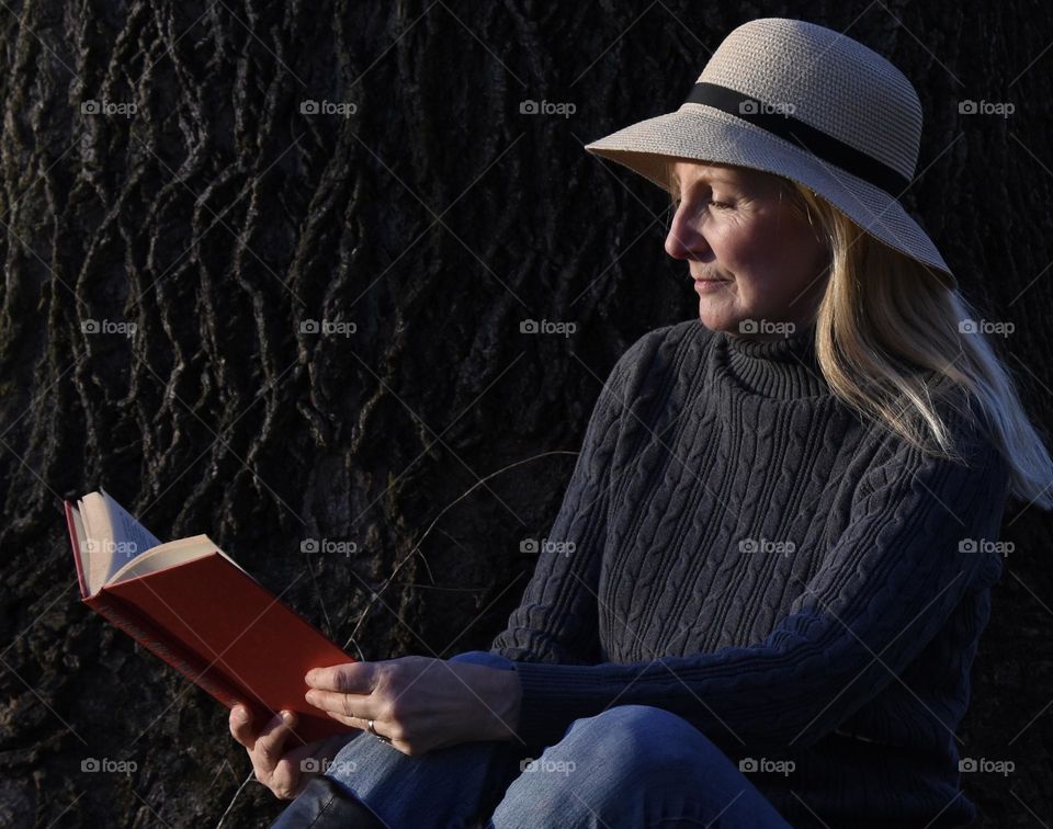 Woman reading a book outside