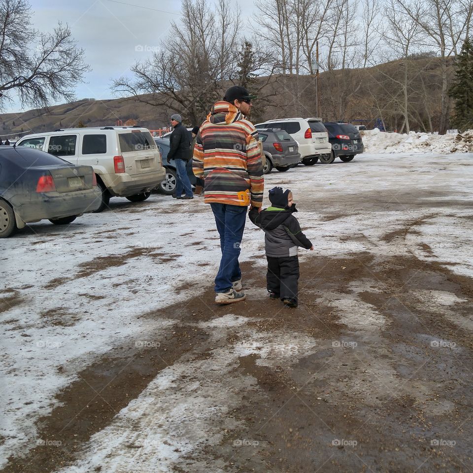father and son walking to the winter festival